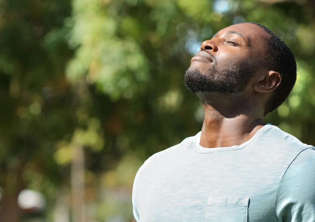 A man breathing deeply among the trees